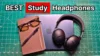Bose wireless over-ear noise cancelling headphones next to glasses, notebook, and Macbook