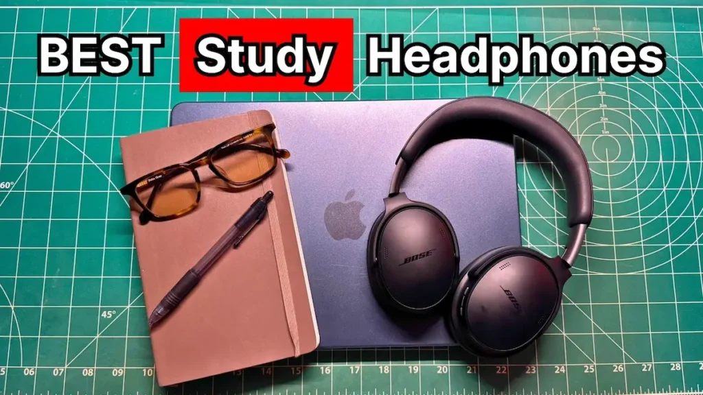 Bose wireless over-ear noise cancelling headphones next to glasses, notebook, and Macbook