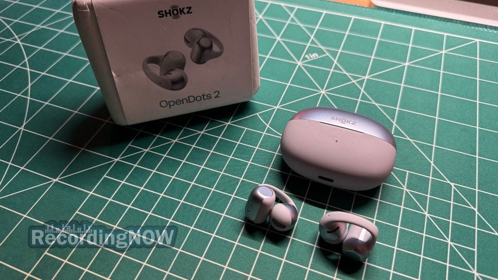 SHOKZ OpenDots 2 open ear clip on earbuds and charging case next to original box packaging