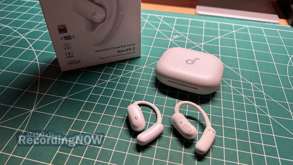 Soundcore AeroFit 2 open ear earbuds and charging case next to original box packaging