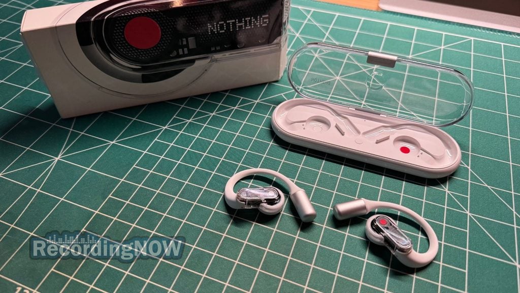 Nothing Ear (Open) open ear earbuds and charging case next to original box packaging