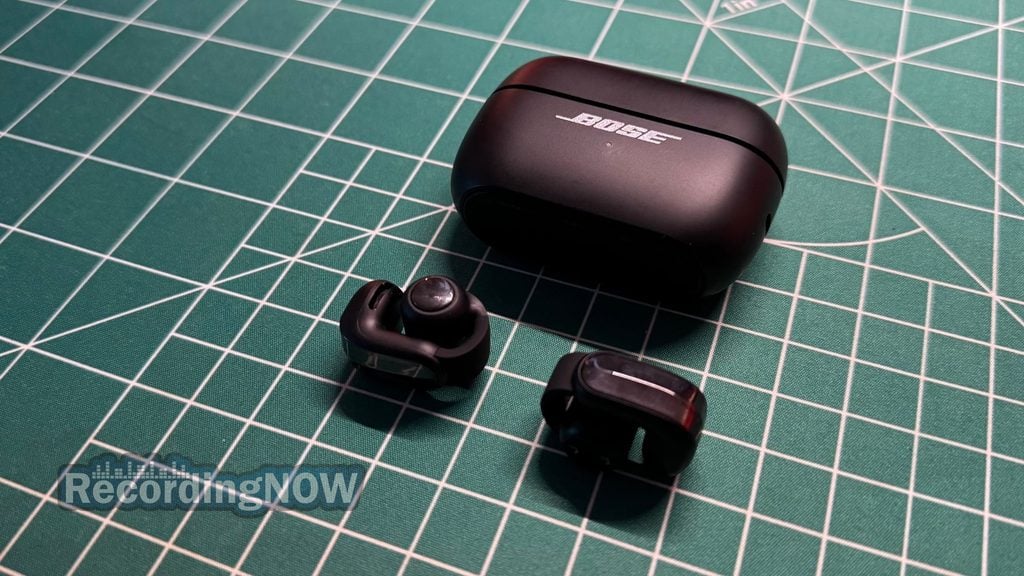 Bose Ultra Open Earbuds 2nd Gen clip on earbuds next to charging case on desk