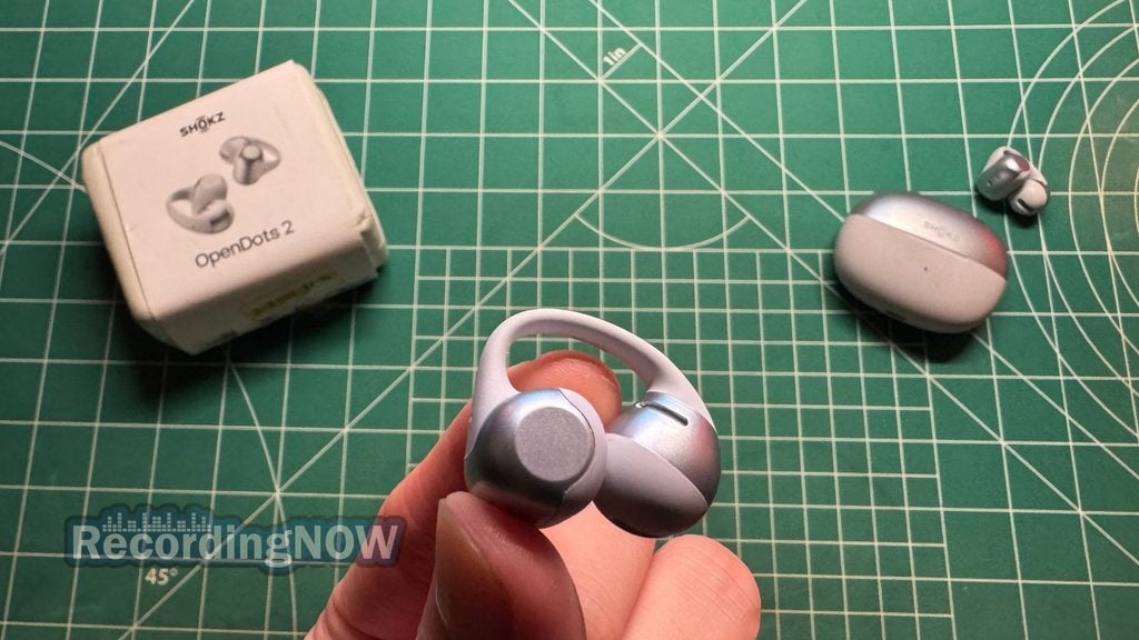 Holding SHOKZ OpenDots 2 wireless clip on earbud in hand
