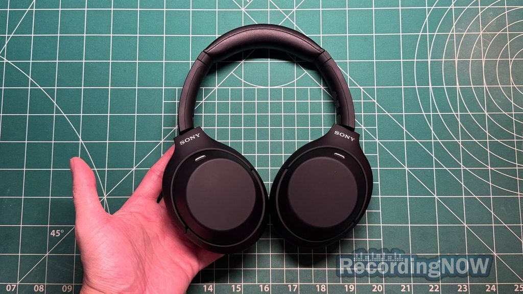 Holding Sony WH-1000XM4C 2nd Gen headphones in hand
