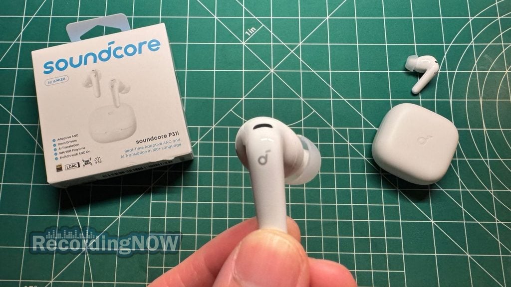 Holding Anker Soundcore P31i wireless earbud in hand