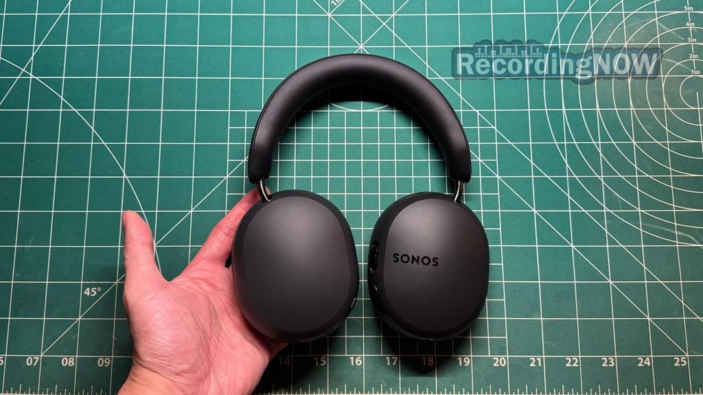 Holding Sonos Ace Ultra wireless noise cancelling headphones in hand