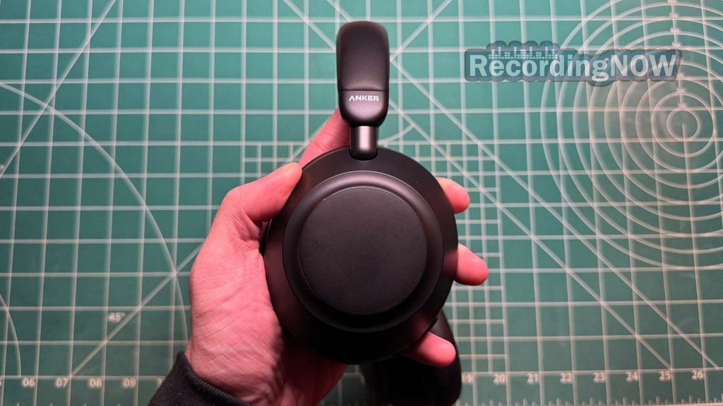 Holding Earcup of Anker Soundcore Space 2 Pro headphones in hand