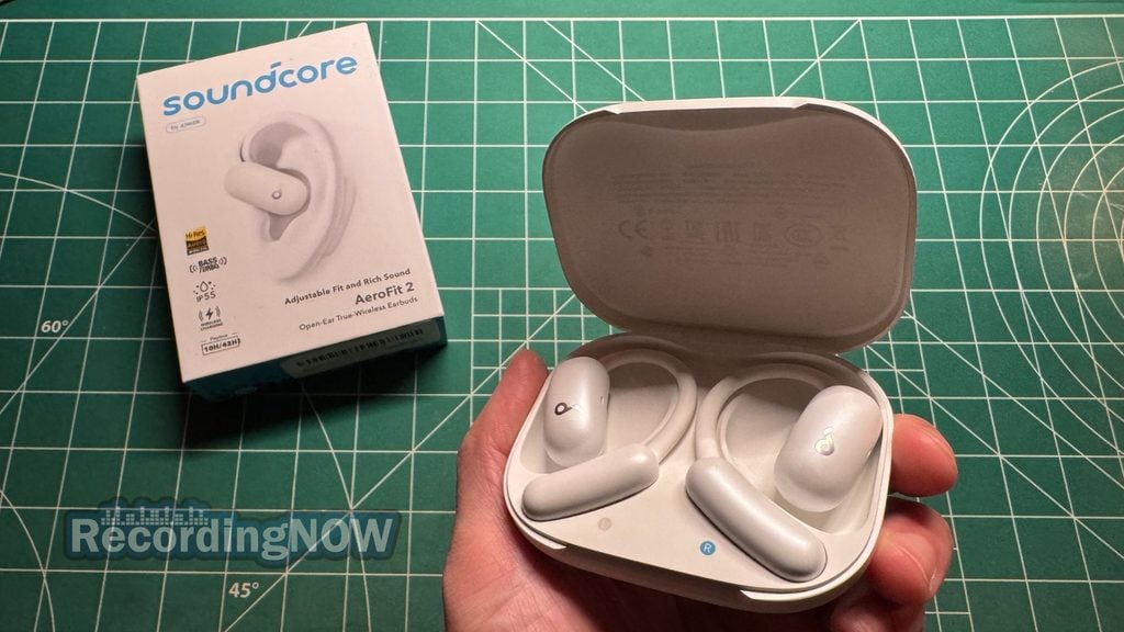 Holding Anker Soundcore AeroFit 2 charging case in hand