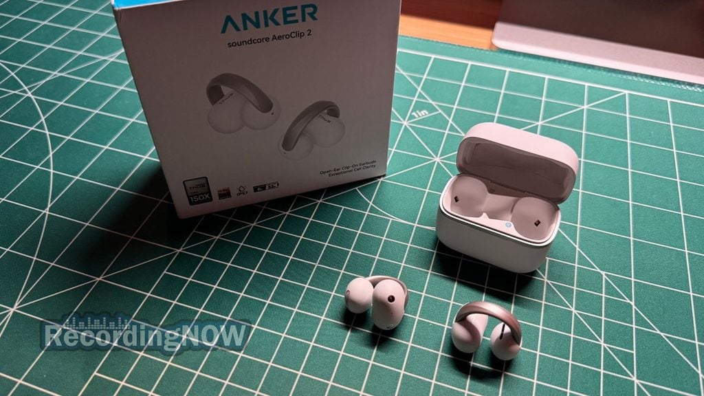 Soundcore AeroClip 2 open ear clip on earbuds and charging case next to original box packaging