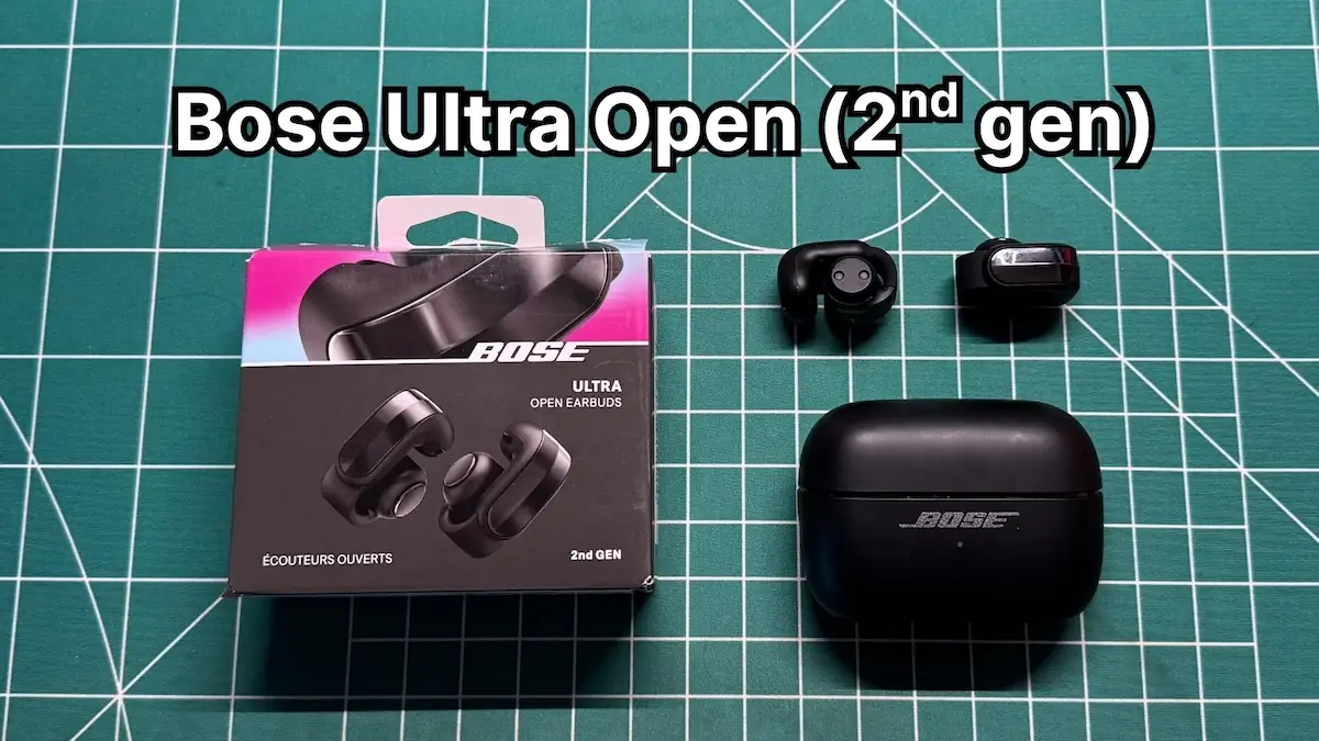 Bose Ultra Open Earbuds 2nd Gen in black next to charging case and box