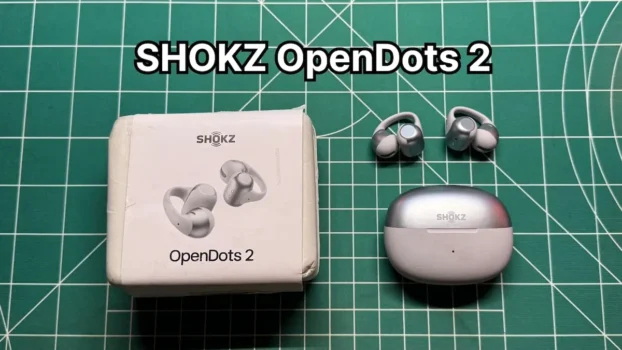SHOKZ OpenDots 2 clip on open ear earbuds next to charging case and box