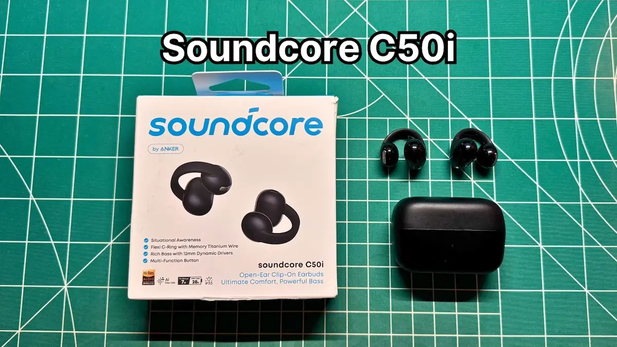 Anker Soundcore C50i wireless clip on earbuds next to charging case and box packaging